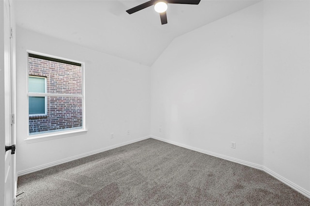 carpeted spare room with vaulted ceiling and ceiling fan