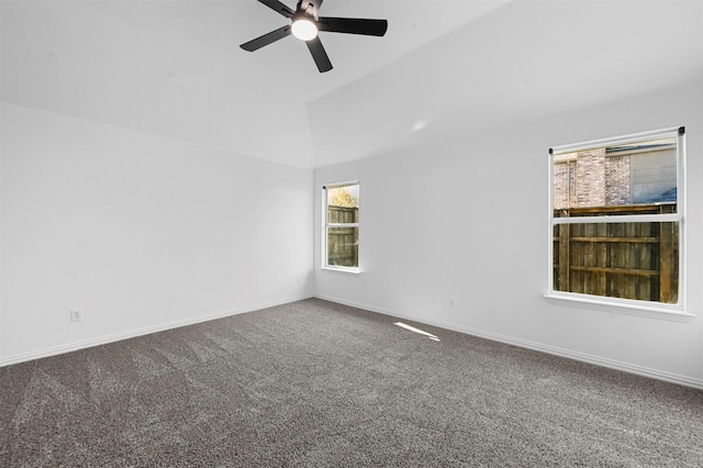 carpeted empty room with ceiling fan and vaulted ceiling