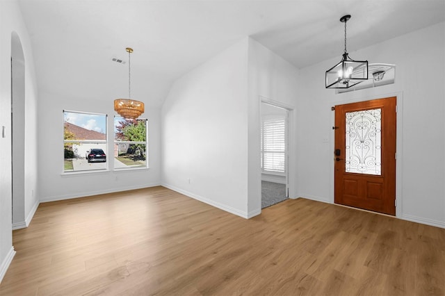 entrance foyer with light hardwood / wood-style floors, a chandelier, and a healthy amount of sunlight