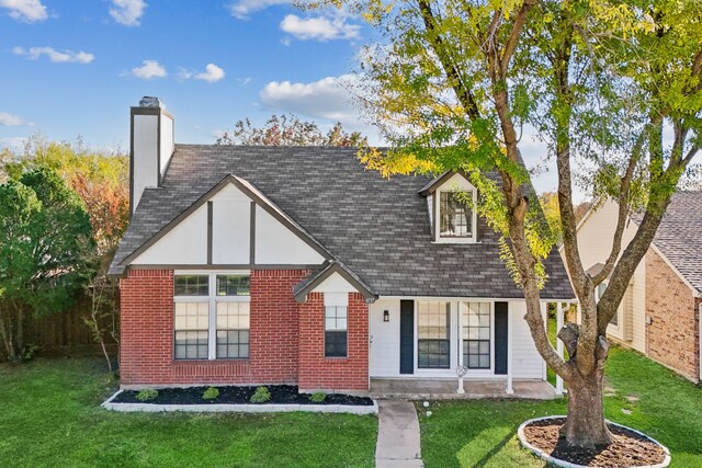 view of front of house featuring a front yard and covered porch