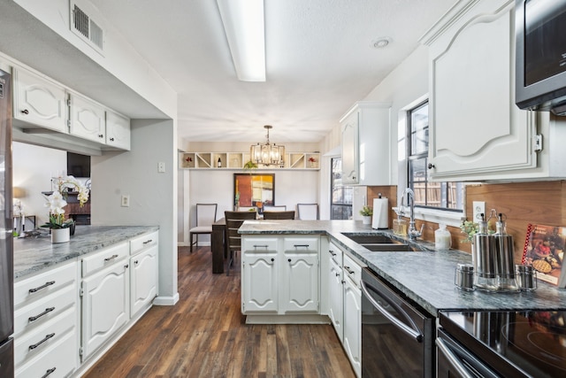 kitchen featuring pendant lighting, white cabinetry, dark hardwood / wood-style flooring, kitchen peninsula, and stainless steel appliances