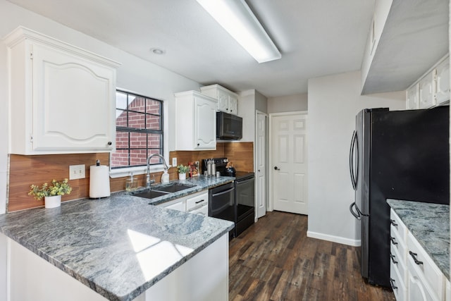 kitchen with sink, white cabinets, black appliances, and dark hardwood / wood-style floors