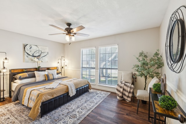 bedroom with dark hardwood / wood-style floors and ceiling fan