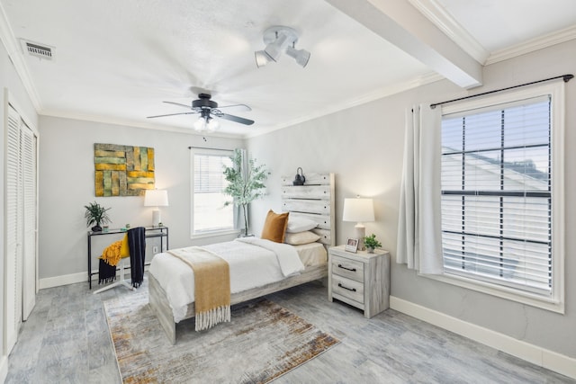 bedroom with ceiling fan, light hardwood / wood-style flooring, and crown molding