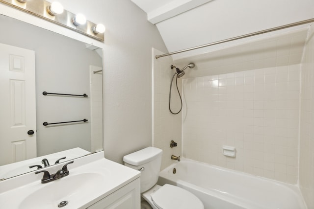 full bathroom featuring vanity, toilet, tiled shower / bath, and vaulted ceiling