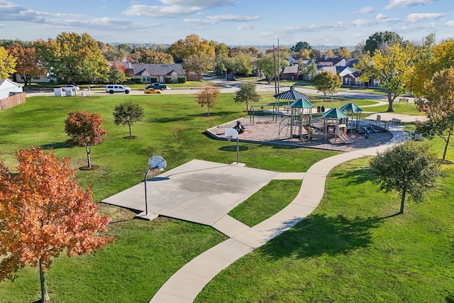 view of home's community featuring a playground and a lawn