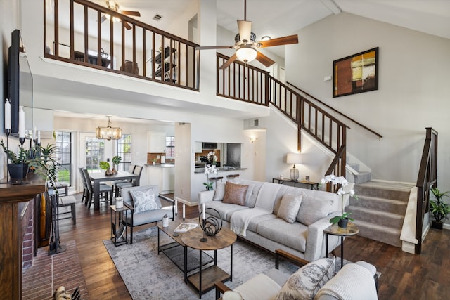 living room featuring high vaulted ceiling, dark hardwood / wood-style floors, and ceiling fan with notable chandelier