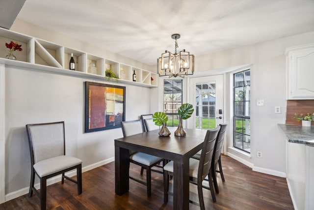 dining room featuring dark hardwood / wood-style floors and a chandelier