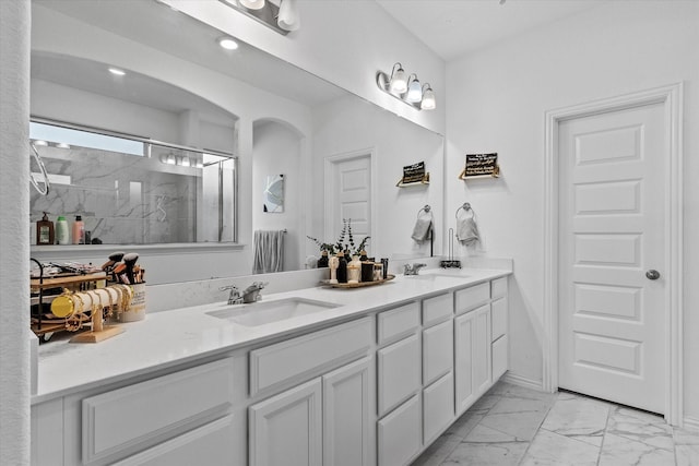 bathroom with vanity and a shower with door