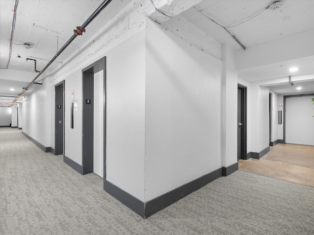 329 E Colorado Blvd Unit 202, Dallas, TX 75203 - hall with baseboards, recessed lighting, elevator, and carpet floors