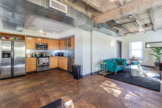 kitchen with track lighting and appliances with stainless steel finishes