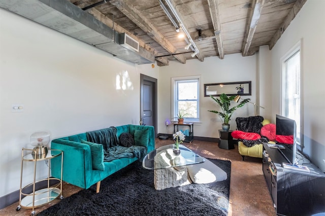 living room featuring rail lighting and beamed ceiling