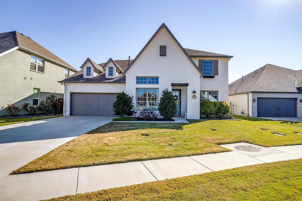 view of front of home with a front lawn and a garage