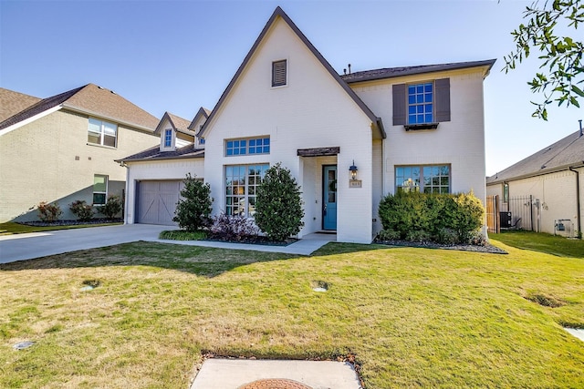 view of front of house featuring a garage and a front lawn