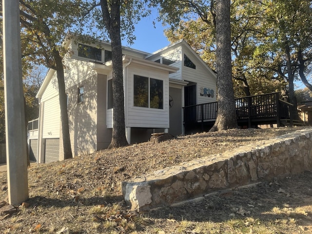 view of side of home with a wooden deck