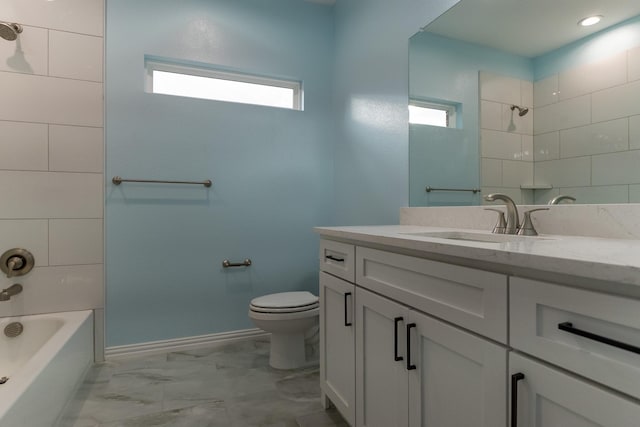 full bathroom featuring toilet, tiled shower / bath combo, and vanity