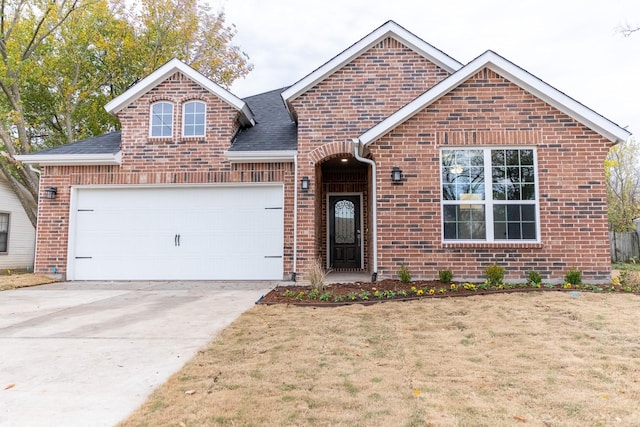 front of property with a front yard and a garage