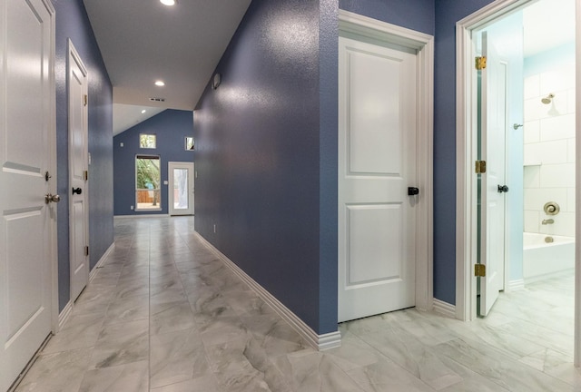 corridor featuring lofted ceiling