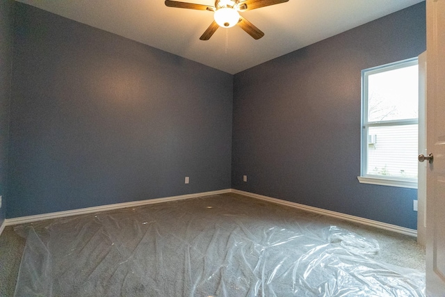 spare room featuring ceiling fan and carpet