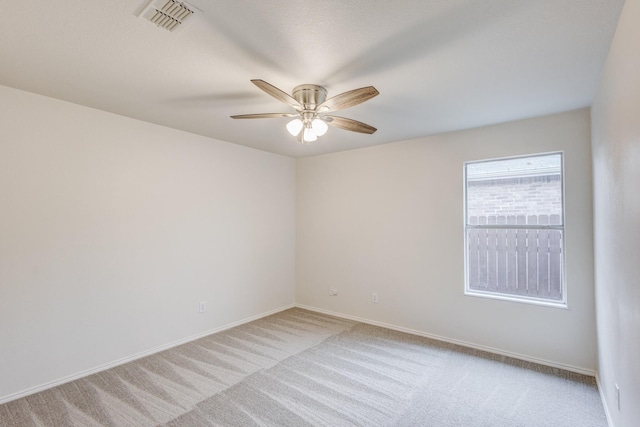 unfurnished room with ceiling fan and light colored carpet