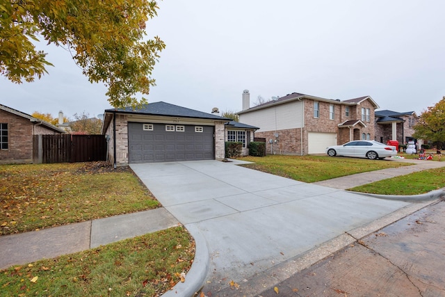 view of front of property with a front lawn and a garage