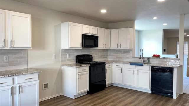 kitchen featuring a sink, black appliances, white cabinets, and dark wood-style flooring