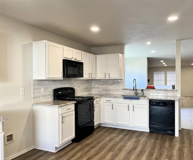 kitchen featuring sink, white cabinetry, black appliances, light stone countertops, and dark hardwood / wood-style flooring