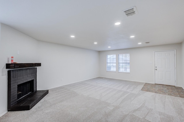 unfurnished living room featuring light carpet and a fireplace