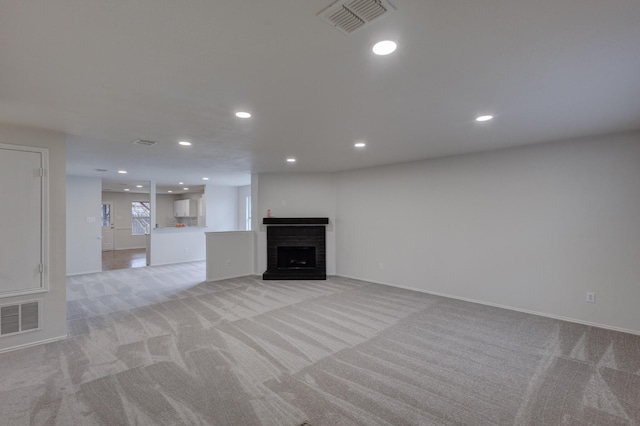 unfurnished living room with light colored carpet