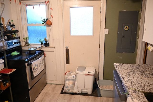 kitchen featuring light stone counters, stainless steel electric range oven, and electric panel