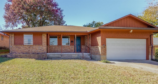 view of front facade with a front yard, a porch, and a garage