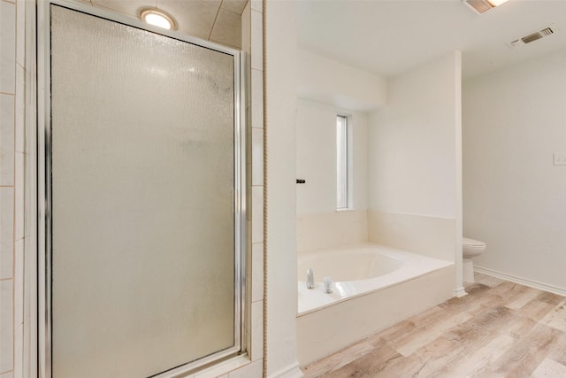 bathroom featuring hardwood / wood-style floors and shower with separate bathtub