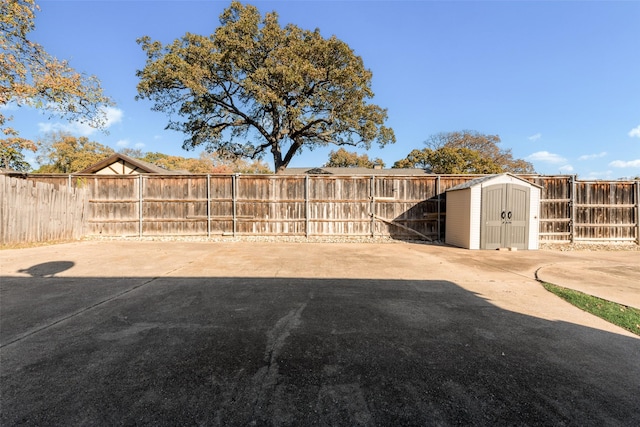 view of yard with a shed and a patio area