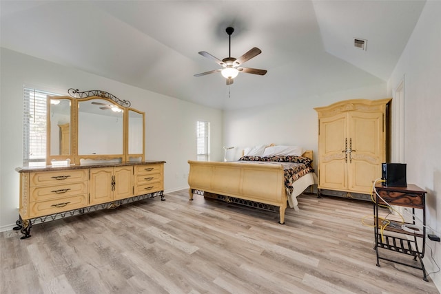 bedroom featuring ceiling fan, vaulted ceiling, and light wood-type flooring