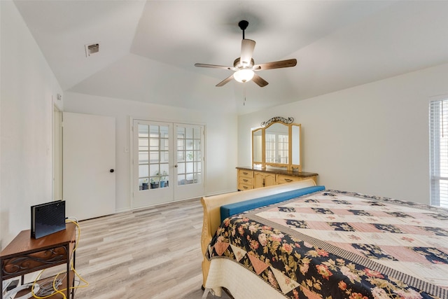 bedroom with ceiling fan, light hardwood / wood-style floors, lofted ceiling, and multiple windows