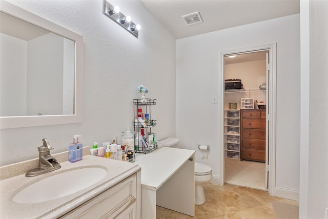 bathroom with vanity, tile patterned floors, and toilet