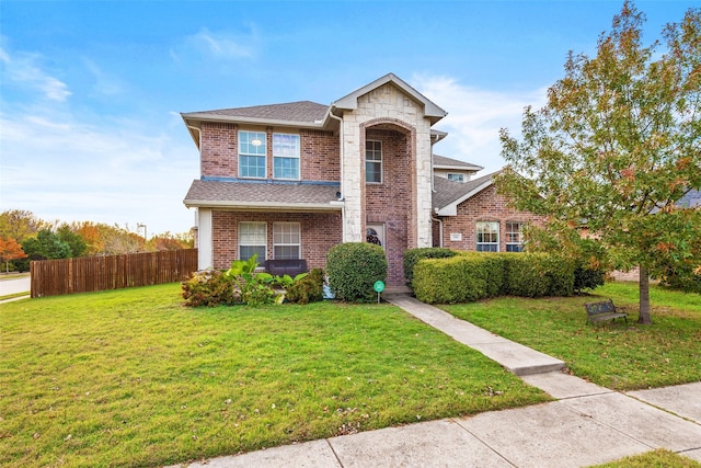 view of property featuring a front lawn