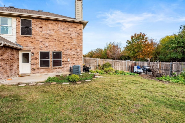 view of yard featuring central AC unit and a patio area