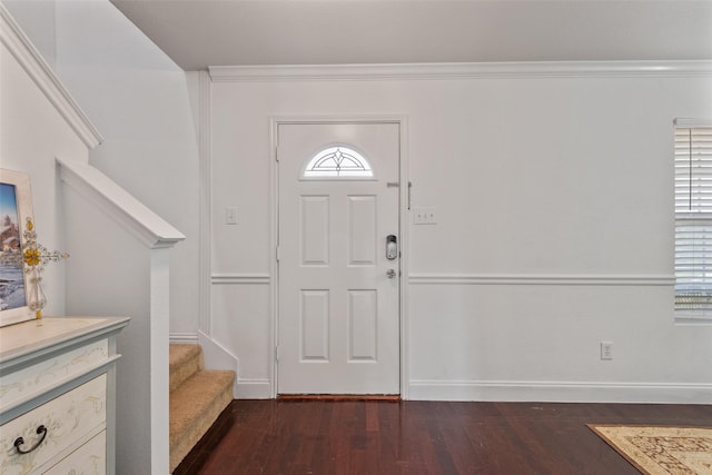 entryway with ornamental molding and dark hardwood / wood-style flooring