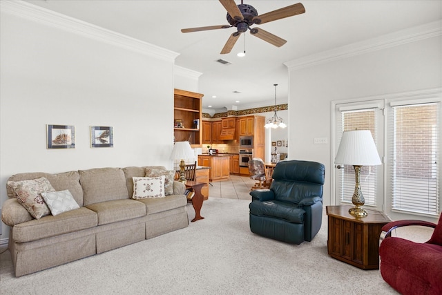 living room featuring ceiling fan with notable chandelier, ornamental molding, and light carpet