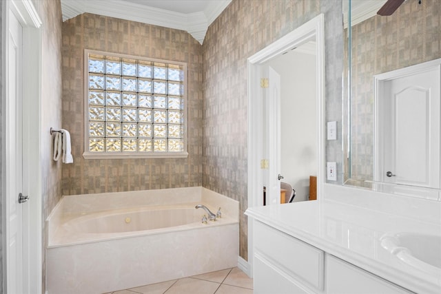 bathroom with tile patterned flooring, vanity, a bathtub, and crown molding