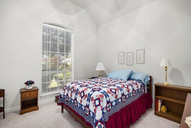 carpeted bedroom with lofted ceiling