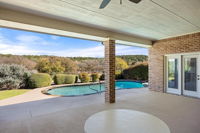 view of pool with a patio and ceiling fan