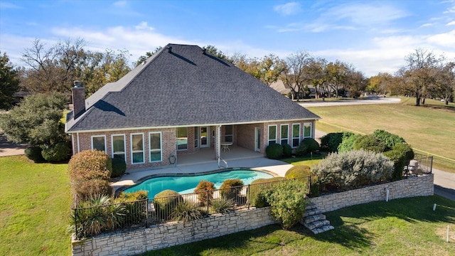 back of property featuring a patio area and a lawn