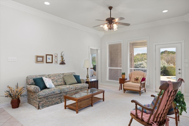 carpeted living room featuring ceiling fan and crown molding