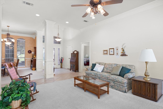 tiled living room featuring ceiling fan with notable chandelier, ornate columns, and crown molding