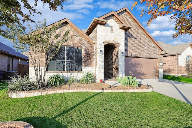 view of front of house with a front yard and a garage