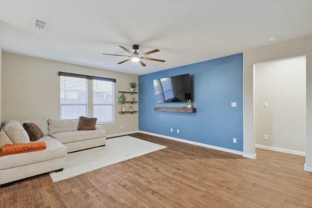 living room featuring light wood-type flooring and ceiling fan