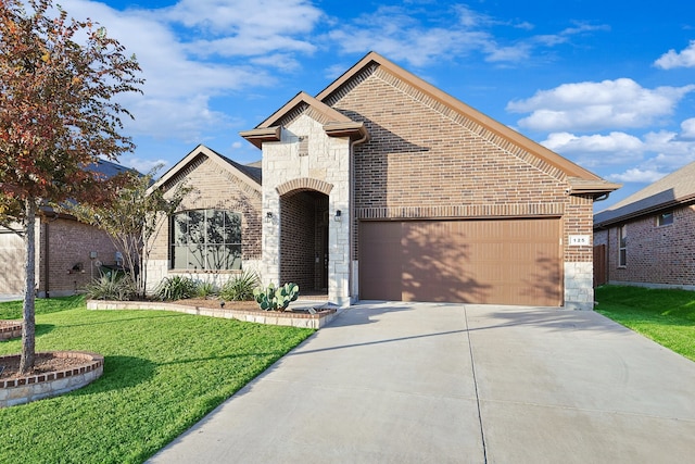 view of front of property featuring a garage and a front yard