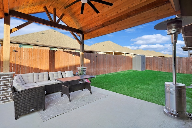 view of patio with ceiling fan, an outdoor hangout area, and a storage unit